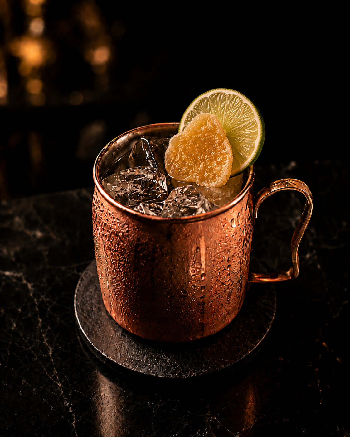Moscow mule in a copper mug with candied ginger and lime